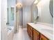 Bright bathroom showcasing double sink vanity and neutral tile flooring leading to a shower and tub at 567 Leah Drive, Powder Springs, GA 30127