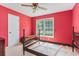 Bedroom featuring red walls, a large window, and carpeted floors at 567 Leah Drive, Powder Springs, GA 30127