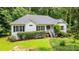 Charming ranch style home with well-maintained landscaping, mature trees, and a welcoming entrance at 567 Leah Drive, Powder Springs, GA 30127