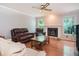 Cozy living room with hardwood floors, a fireplace, and comfortable furniture at 567 Leah Drive, Powder Springs, GA 30127