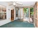 Enclosed sunroom with glass panels and fan, leading to an exterior deck, offering indoor-outdoor living at 567 Leah Drive, Powder Springs, GA 30127