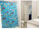 Bathroom with a fun car-themed shower curtain, toilet, and single sink at 735 Sweethaven Ln, Loganville, GA 30052