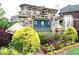 Stone sign for the Hollowstone community surrounded by colorful flowerbeds and greenery at 735 Sweethaven Ln, Loganville, GA 30052