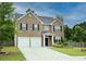 Charming two-story brick home with a two-car garage and well-maintained lawn at 735 Sweethaven Ln, Loganville, GA 30052