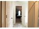 Hallway leading to the primary bedroom and bathroom with a shower at 735 Sweethaven Ln, Loganville, GA 30052