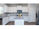 Modern kitchen featuring white cabinets, granite countertops, and stainless steel appliances at 735 Sweethaven Ln, Loganville, GA 30052