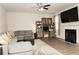 Living room with a fireplace, TV, and a comfortable gray sectional sofa at 735 Sweethaven Ln, Loganville, GA 30052
