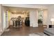 Open-concept living space with hardwood floors flowing from the living room into the kitchen and dining area at 735 Sweethaven Ln, Loganville, GA 30052