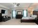 Spacious main bedroom with a sofa, TV, king bed, and en-suite bathroom at 735 Sweethaven Ln, Loganville, GA 30052