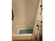 Clean white bathtub with a shower curtain and tiled walls. Features a green bath mat at 1075 Peachtree Ne Walk # 506, Atlanta, GA 30309