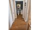 Hallway with hardwood floors leading to a bathroom with a toilet and vanity at 1075 Peachtree Ne Walk # 506, Atlanta, GA 30309