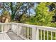 Scenic view from the wooden balcony shows lush greenery and other houses beyond the white railing at 1250 Oxley Nw Ln, Atlanta, GA 30307