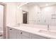 Bathroom featuring a dual sink vanity, large mirror, and a tiled walk-in shower at 1250 Oxley Nw Ln, Atlanta, GA 30307