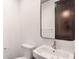 Clean half bathroom featuring a modern sink, toilet, and stylish mirror at 1250 Oxley Nw Ln, Atlanta, GA 30307