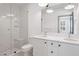 Modern bathroom featuring double vanity, white cabinets, and a glass-enclosed shower with a built-in bench at 1250 Oxley Nw Ln, Atlanta, GA 30307