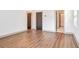 Bedroom featuring wood-look flooring, modern trim, and two doors at 1250 Oxley Nw Ln, Atlanta, GA 30307