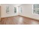 Bright, airy bedroom featuring three windows, modern trim, and wood-look flooring at 1250 Oxley Nw Ln, Atlanta, GA 30307