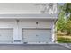 Two-car garage with white doors and a view of the home's exterior, including address number at 1250 Oxley Nw Ln, Atlanta, GA 30307