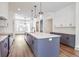 Modern kitchen with a large center island, pendant lights, and stainless steel appliances at 1250 Oxley Nw Ln, Atlanta, GA 30307