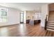 Well-lit open living space with hardwood floors, modern kitchen, and a staircase at 1250 Oxley Nw Ln, Atlanta, GA 30307