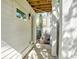Side patio featuring a white siding wall, concrete floor, and view of an outdoor landscape at 1250 Oxley Nw Ln, Atlanta, GA 30307