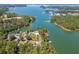 Expansive aerial view of a lakeside property surrounded by lush greenery and tranquil water at 3441 Shoreland Dr, Buford, GA 30518