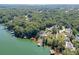 Stunning aerial view of a lakeside community with lush greenery and boat docks on the lake at 3441 Shoreland Dr, Buford, GA 30518