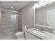 Bathroom with a glass enclosed shower, marble countertop, and neutral gray color palette at 3441 Shoreland Dr, Buford, GA 30518