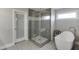 Modern bathroom boasting a glass shower and standalone soaking tub with neutral tilework at 3441 Shoreland Dr, Buford, GA 30518