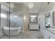 Modern bathroom with a glass shower, soaking tub, and double sink vanity with marble countertop at 3441 Shoreland Dr, Buford, GA 30518