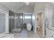 This sleek, modern bathroom features a glass shower enclosure and a standalone soaking tub at 3441 Shoreland Dr, Buford, GA 30518
