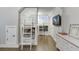 Bedroom featuring built-in bunk beds, hardwood floors, TV, and a neutral color palette at 3441 Shoreland Dr, Buford, GA 30518