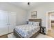 This cozy bedroom features neutral decor, carpeted floors, and an ensuite bathroom at 3441 Shoreland Dr, Buford, GA 30518