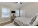 Cozy bedroom featuring a large window, television, and patterned bedding at 3441 Shoreland Dr, Buford, GA 30518