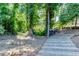 Wooden steps leading to the private dock and lake access with lush trees around at 3441 Shoreland Dr, Buford, GA 30518