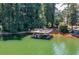 This waterfront property features a private dock, boat slip and relaxing seating area perfect for entertaining at 3441 Shoreland Dr, Buford, GA 30518