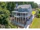 Beautiful two-story home with a covered patio, hot tub, outdoor living area, and well-manicured lawn at 3441 Shoreland Dr, Buford, GA 30518