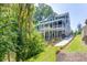 Two-story house with a covered porch, and a stone walkway on a beautiful landscaped lawn at 3441 Shoreland Dr, Buford, GA 30518