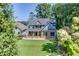 Charming two-story home boasts a brick facade, manicured lawn, and a welcoming front porch at 3441 Shoreland Dr, Buford, GA 30518
