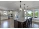 Bright kitchen featuring an island with seating, stainless appliances, and modern lighting at 3441 Shoreland Dr, Buford, GA 30518