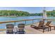 Lounge chairs facing a lake view deck with a wooden railing at 3441 Shoreland Dr, Buford, GA 30518