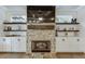Modern living room featuring a stone fireplace, floating shelves, and built-in cabinets at 3441 Shoreland Dr, Buford, GA 30518