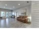 Spacious living room featuring gray vinyl floors, shiplap wall accents, and plenty of natural light at 3441 Shoreland Dr, Buford, GA 30518