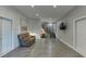 Living room with wood-look floors, shiplap accent wall, brick accent, recessed lighting, and a TV at 3441 Shoreland Dr, Buford, GA 30518