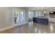 Open-concept living space with access to the patio and a kitchen island at 3441 Shoreland Dr, Buford, GA 30518