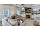 Inviting living room features coffered ceilings, a stone fireplace, and built-in shelving for a cozy and stylish atmosphere at 3441 Shoreland Dr, Buford, GA 30518