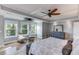 Relax in this spacious bedroom with large windows, wood floors, and contemporary furnishings at 3441 Shoreland Dr, Buford, GA 30518