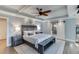 This spacious bedroom features a decorative tray ceiling, ceiling fan, and private ensuite bathroom at 3441 Shoreland Dr, Buford, GA 30518