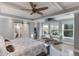 Spacious main bedroom with tray ceilings, and lake views offers a luxurious retreat with modern amenities at 3441 Shoreland Dr, Buford, GA 30518