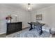 Well-lit office with brick accent wall, desk, dresser, and decorative rug at 3441 Shoreland Dr, Buford, GA 30518